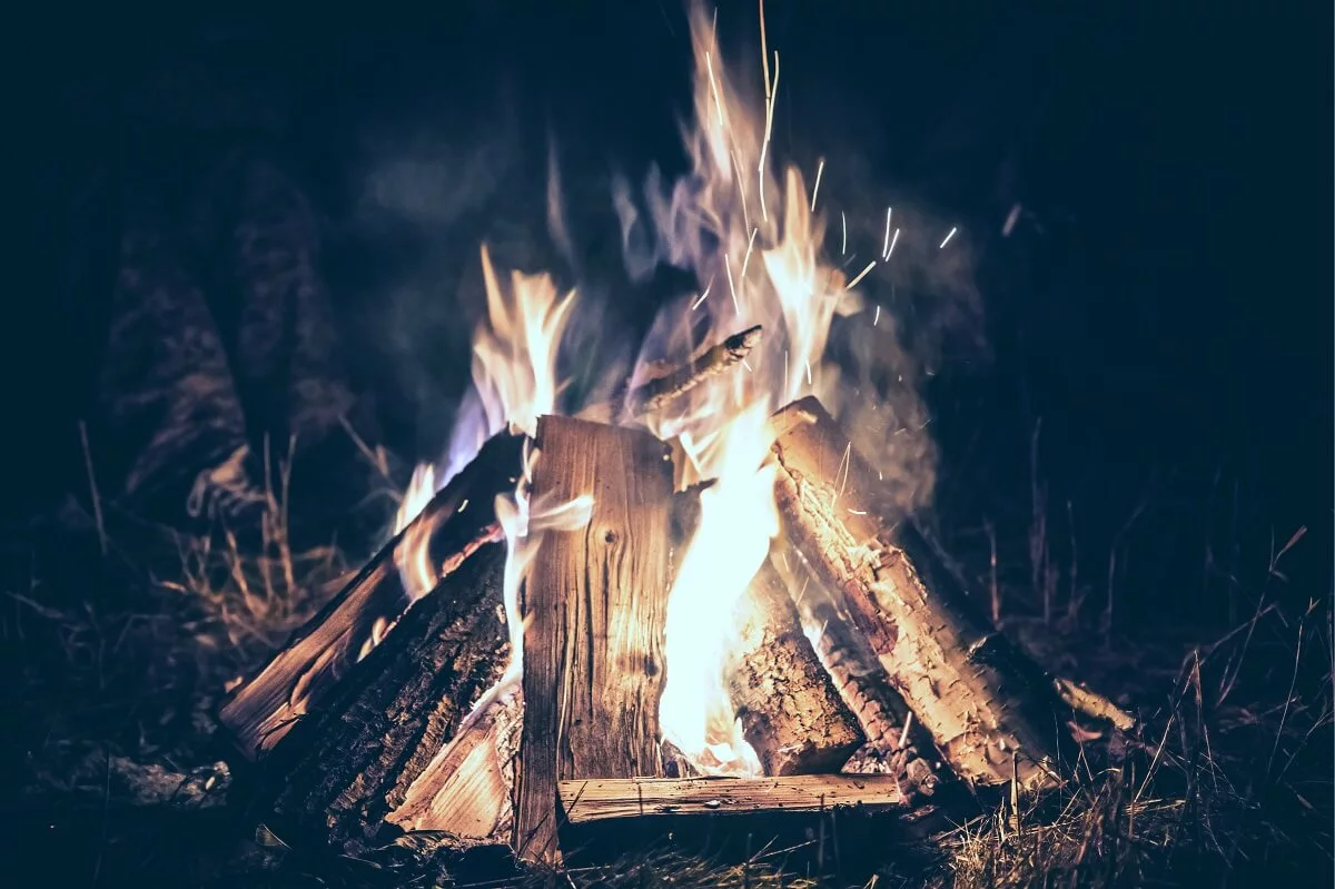 a roaring campfire in the dark