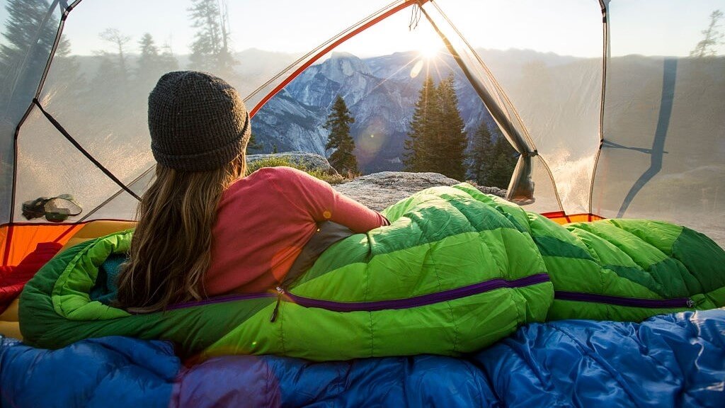 woman camping in a warm sleeping bag