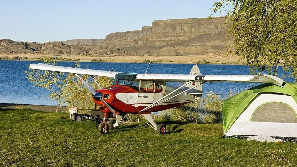 airplane camping near a small lake