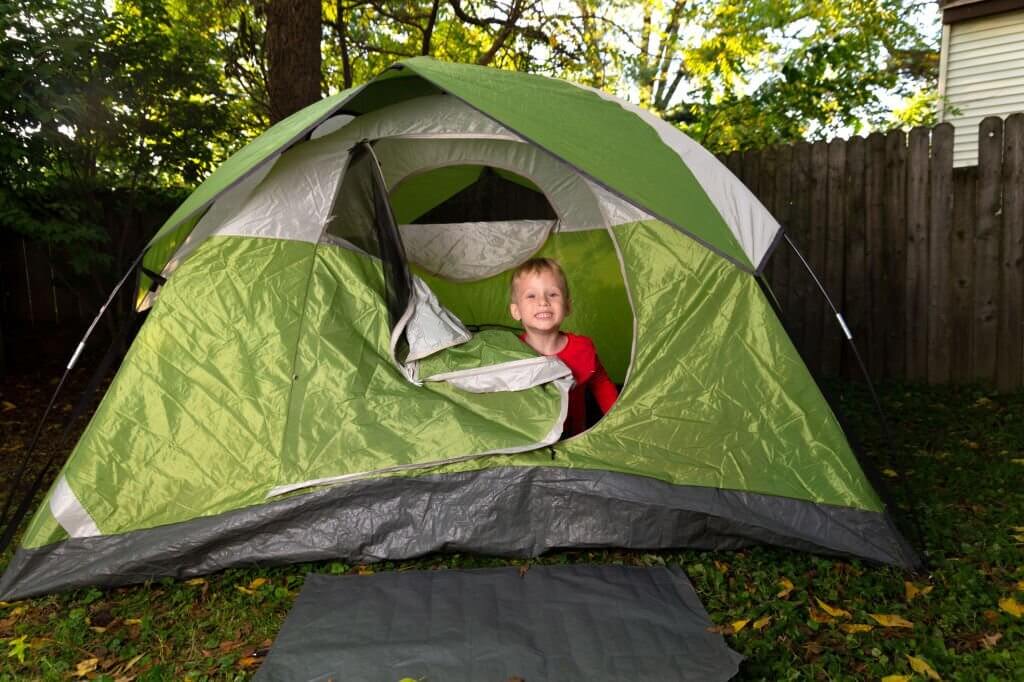 backyard camping - a kid in a tent