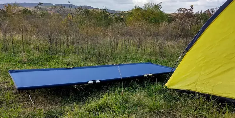 camping cot near a tent