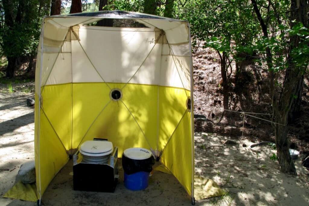 camping toilets in a privacy tent in the bush