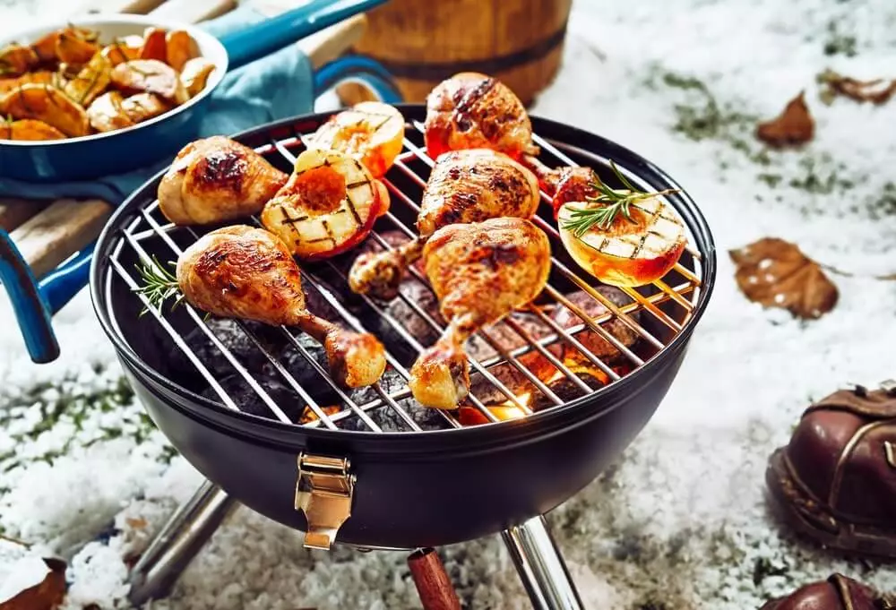 cooking chicken drumsticks on a charcoal grill