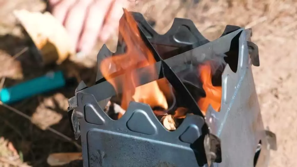 image of wood burning stove with fire on top