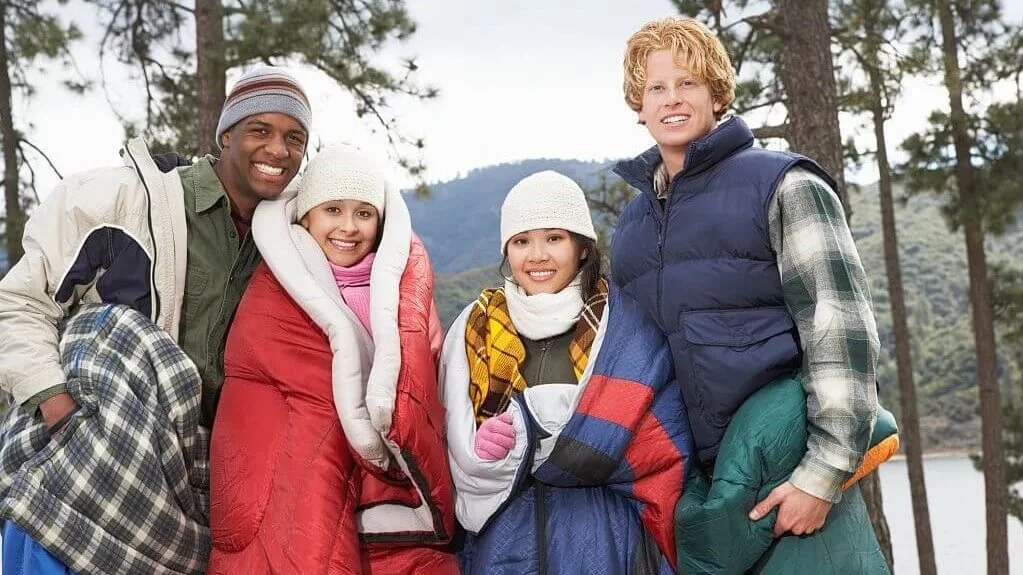 friends wrapped up in camping blankets