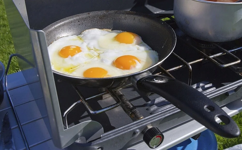 frying eggs on a camping stove