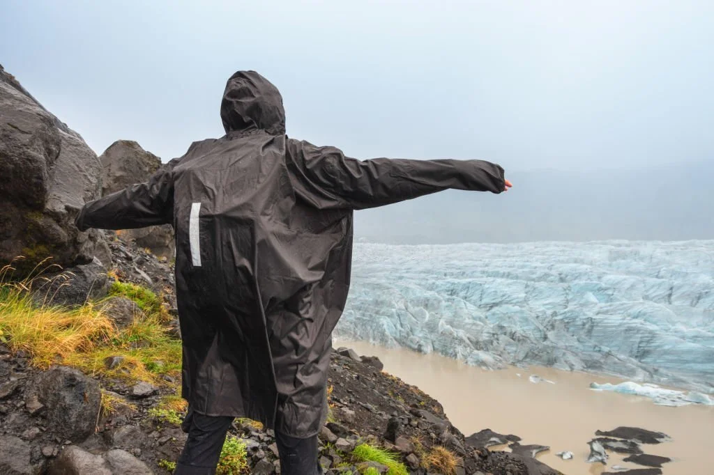 a man wearing a black rain poncho