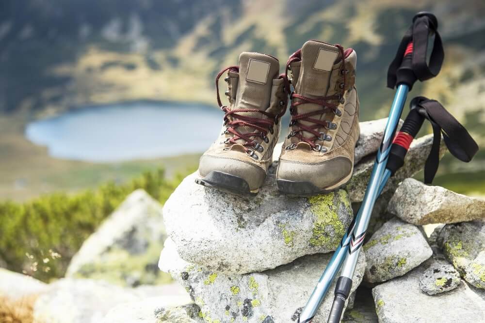 men's hiking boots pair on top of a rock