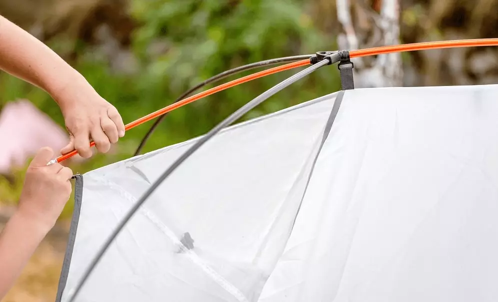 pitching the tent for camping in the rain