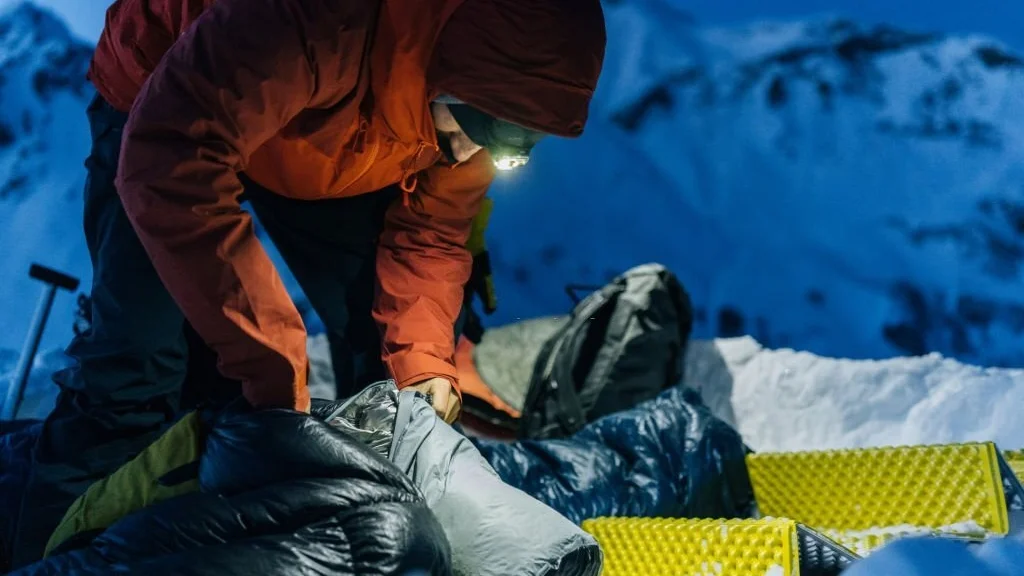 preparing a sleeping bag liner before sleeping outside