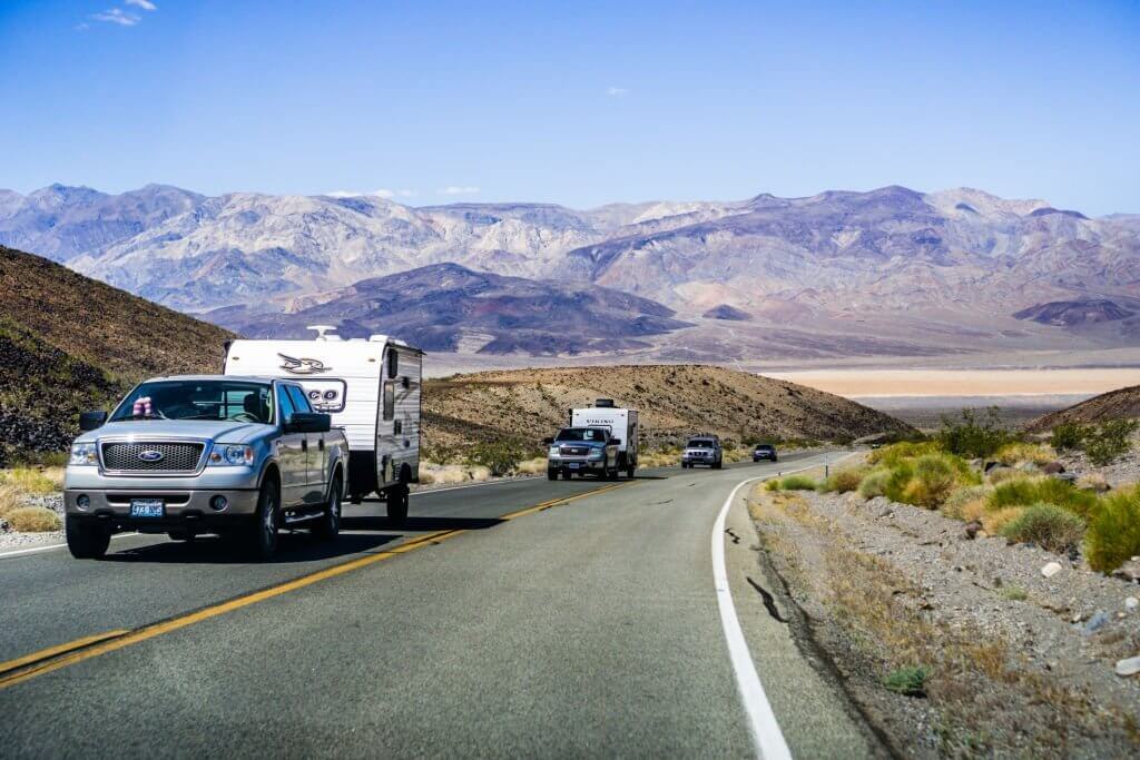pickup trucks with rv on a road trip