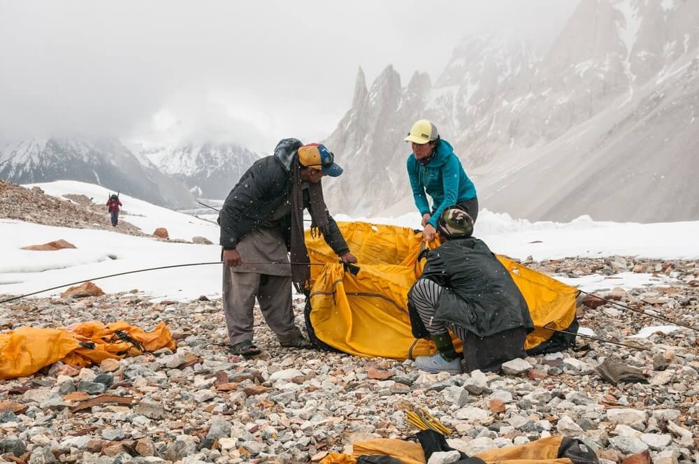 setting up tent in snow