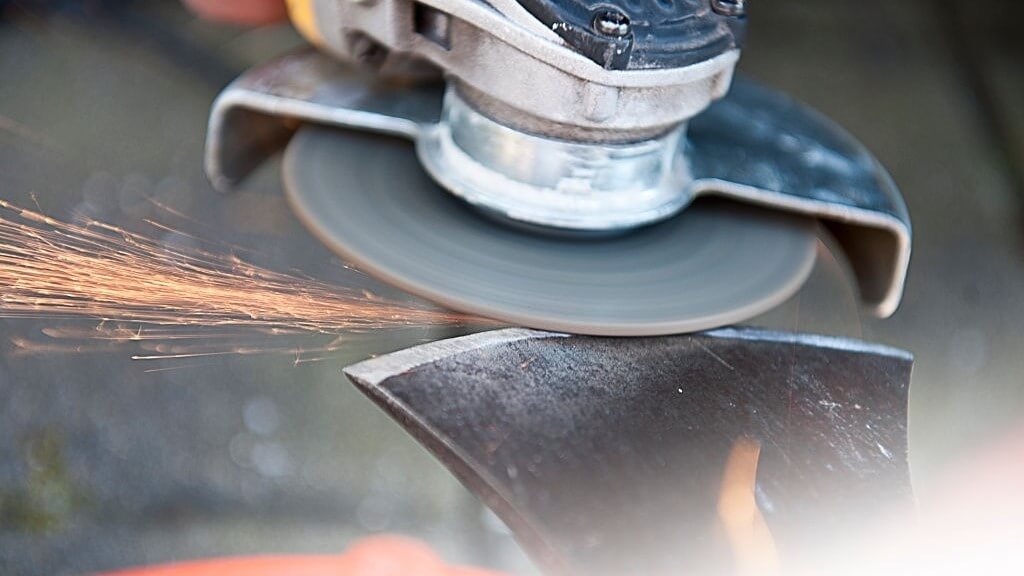 sharpening an axe using a grinder