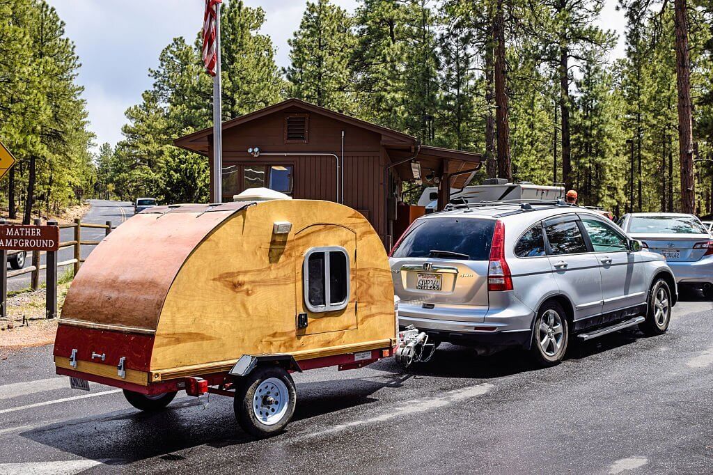 a teardrop trailer being towed by a Honda CRV SUV