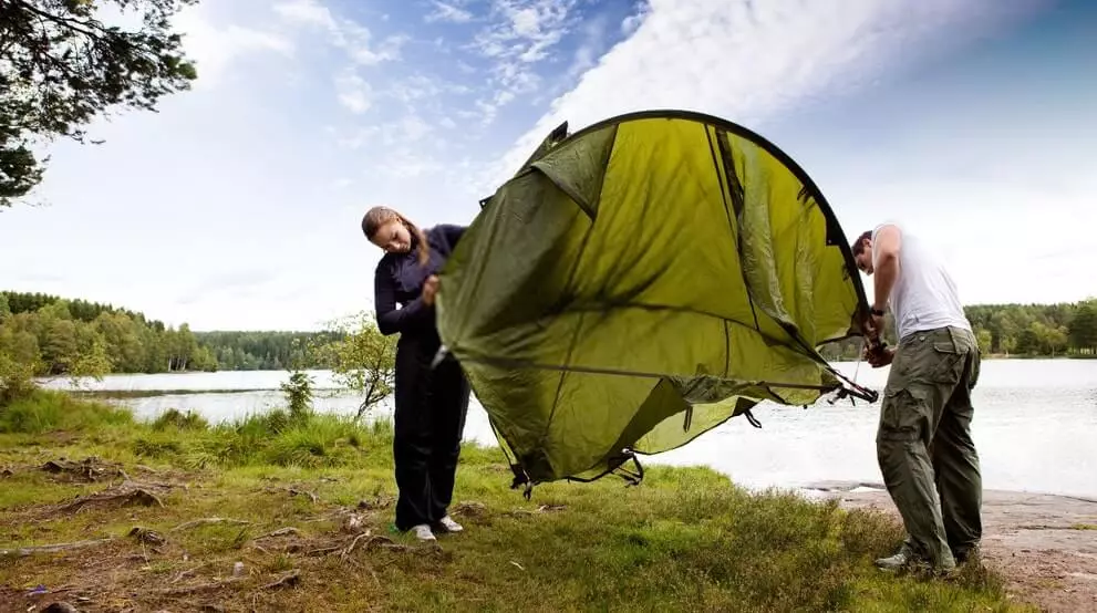 image of male and female checking out the tent during teardown