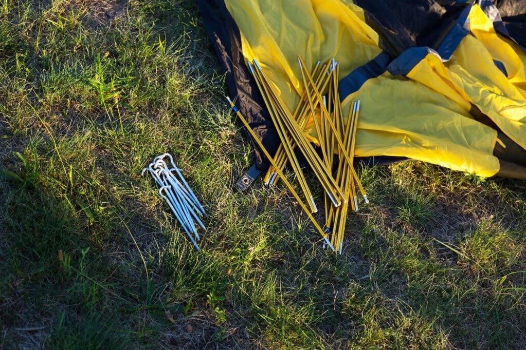 unwrapped camping tent with stakes