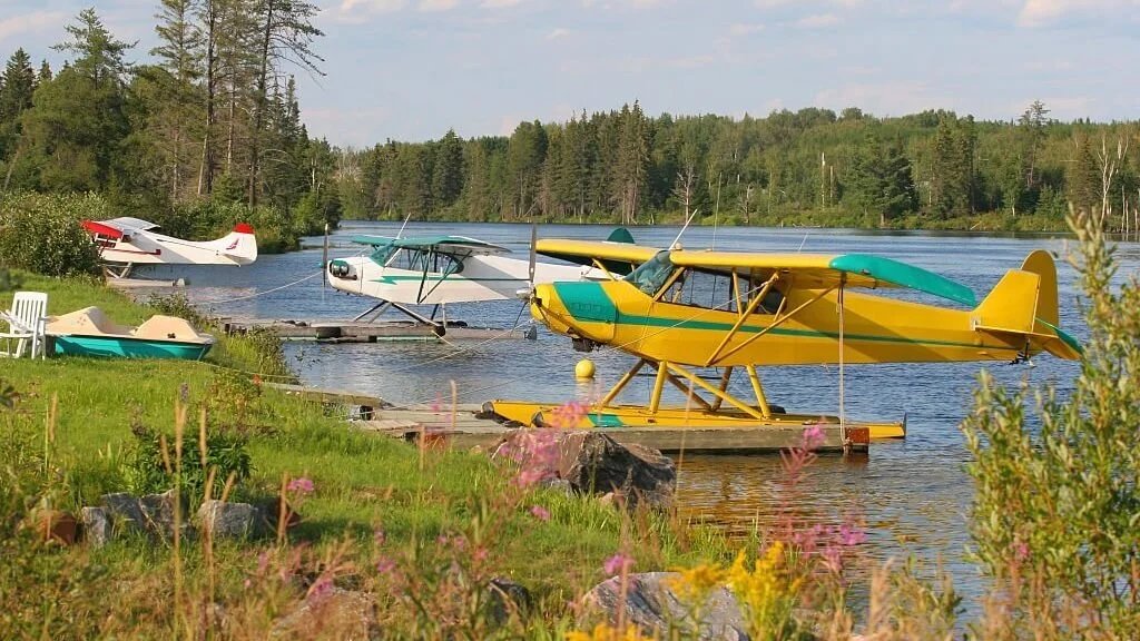 three floater airplanes camping at the lake