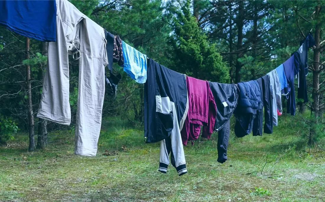 wet clothes hanging on a clothesline in the forest