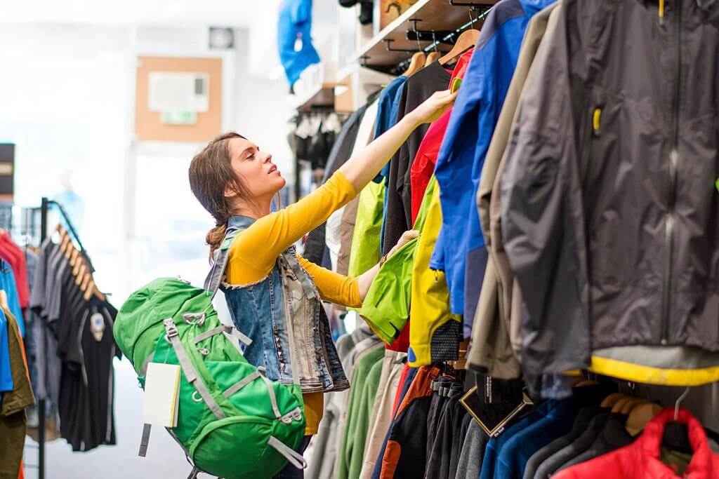 a cwoman shopping in an outdoor gear shop