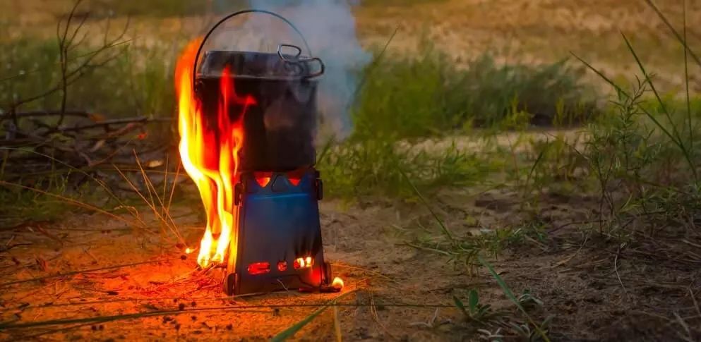 image of cooking stove with raging fire and pot on top