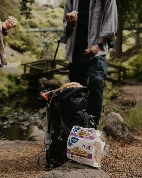 image of a backpack with a snack bag leaning against it
