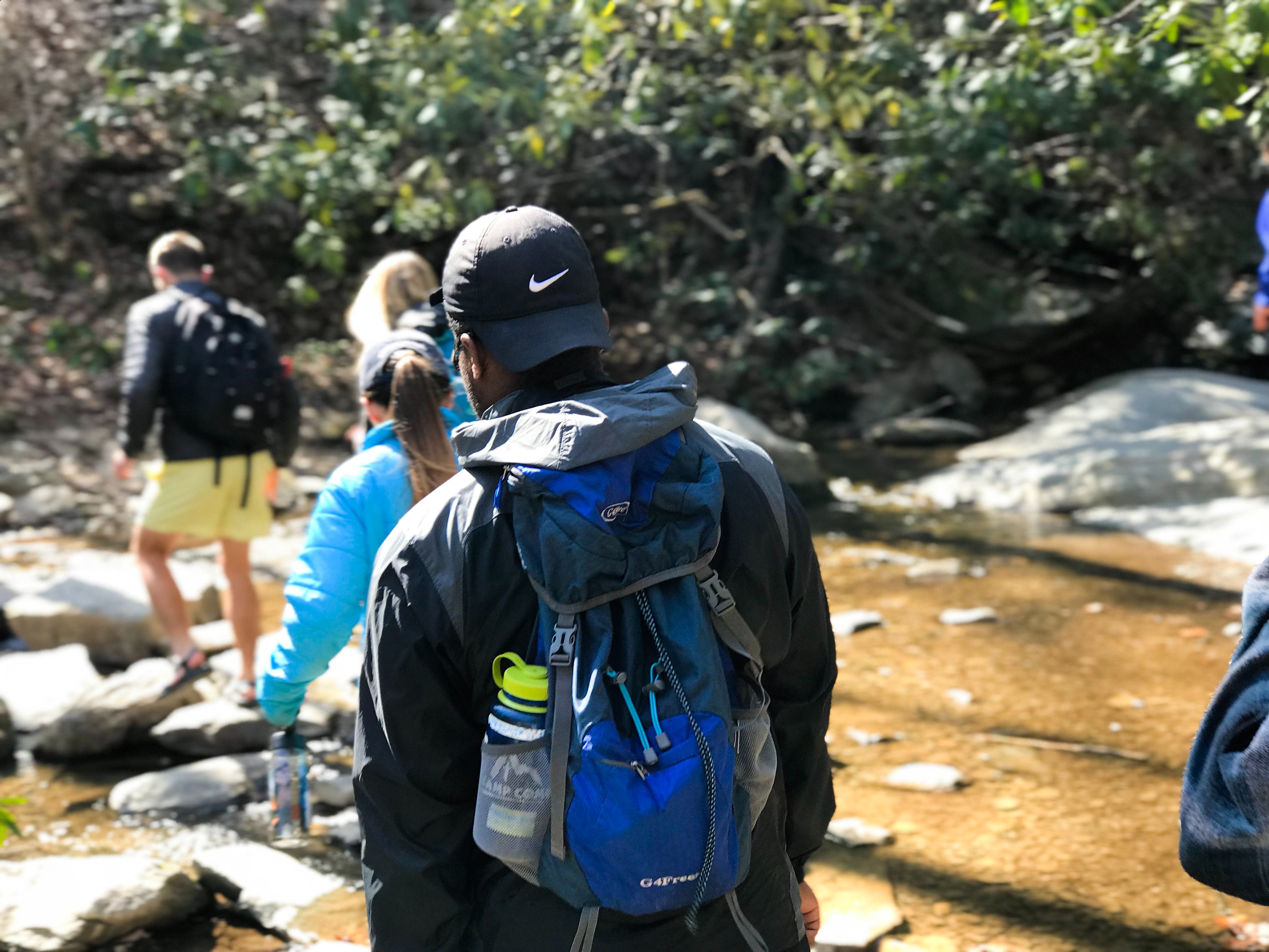 image of a group hiking along a mountain side